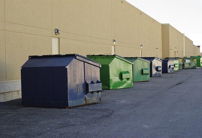 large garbage containers clustered on a construction lot in Green River